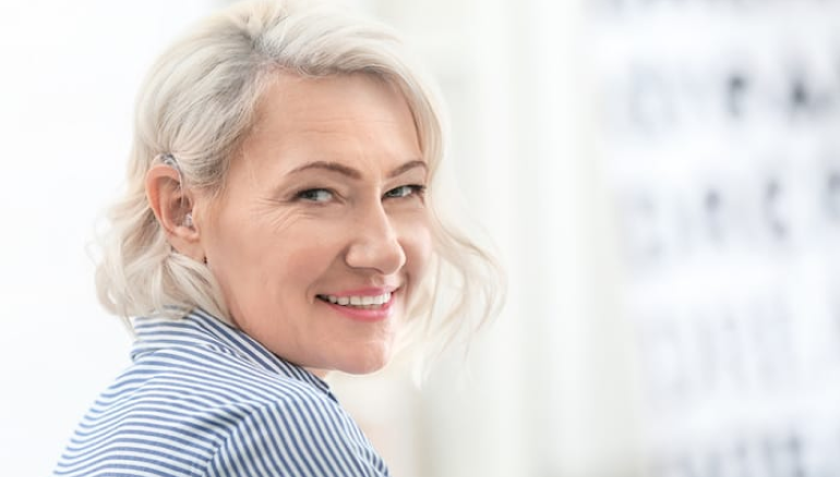 Woman smiling at the camera and feeling relief from BVD symptoms.